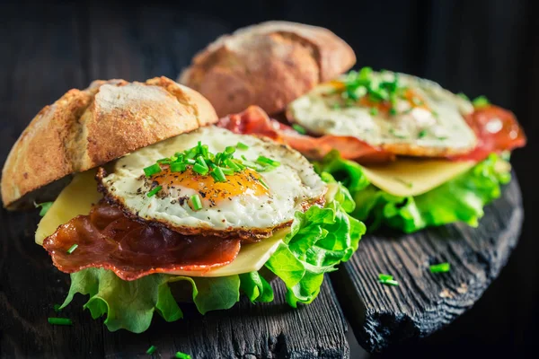 Fresh burger with eggs, cheese and bacon — Stock Photo, Image