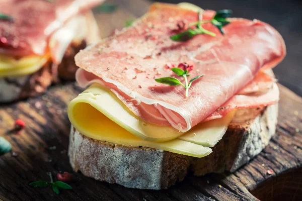 Delicioso sanduíche com queijo e presunto para o café da manhã — Fotografia de Stock