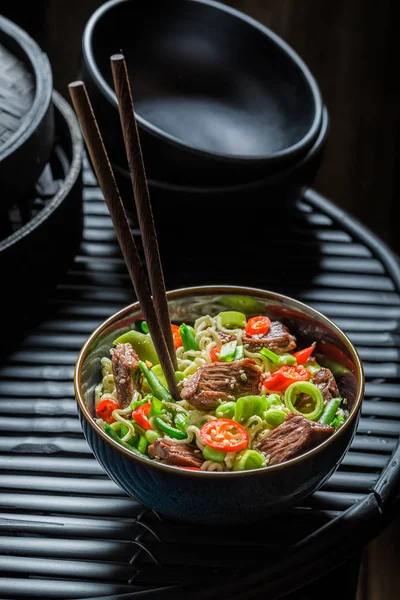 Hot asian noodle with vegetables and beef