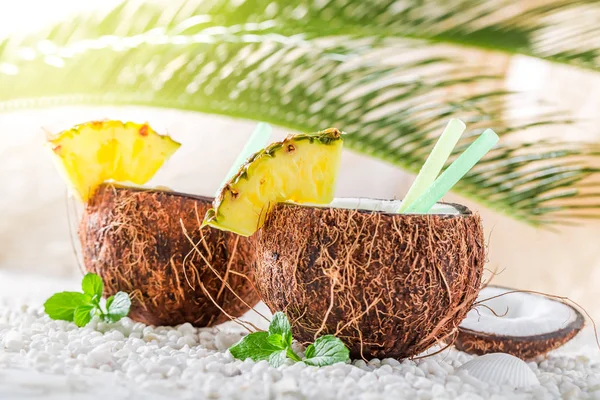 Sweet pinacolada in coconut on sandy beach — Stock Photo, Image