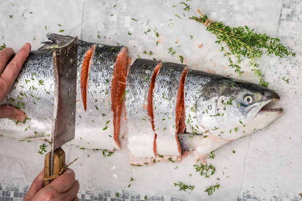 Slicing fresh salmon on an old white table — Stock Photo, Image