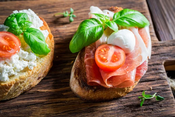 Homemade mix of bruschetta with fresh ingredients for breakfast — Stock Photo, Image