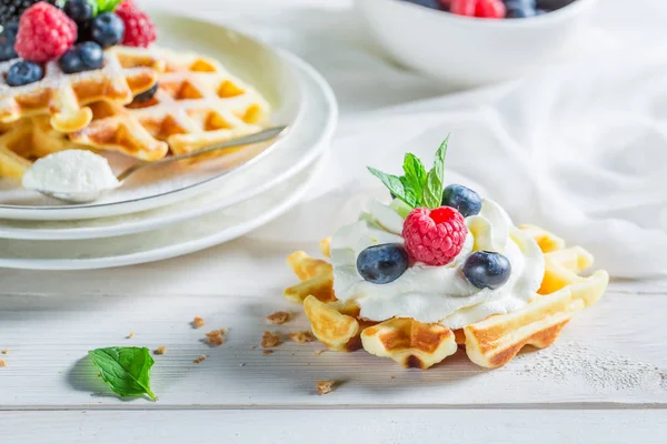 Nahaufnahme von süßen Waffeln mit Beerenfrüchten und Schlagsahne — Stockfoto