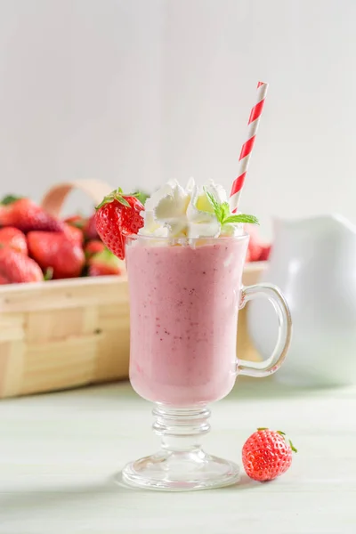 Färsk jordgubbe smoothie gjord av färsk frukt på träbord — Stockfoto