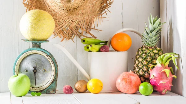 Various tropical fruits on a white table — Stock Photo, Image