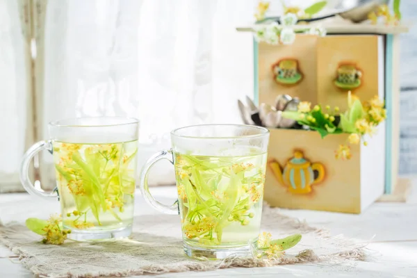 Healing linden tea with honey on white table — Stock Photo, Image