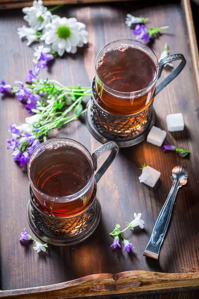 Delicious hot tea with fresh green leaves — Stock Photo, Image