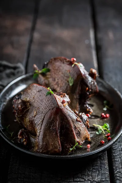 Two roasted pigeons with spices and pepper on dark background — Stock Photo, Image