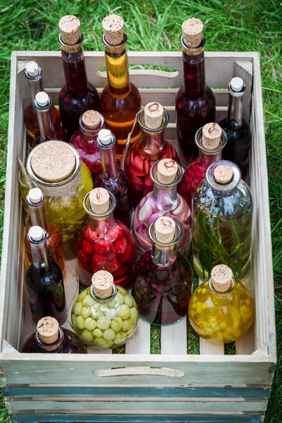 Healthy liqueur with fruits and alcohol in wooden box — Stock Photo, Image