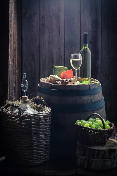 Homemade chardonnay wine and mix of cheese on oak barrel — Stock Photo, Image