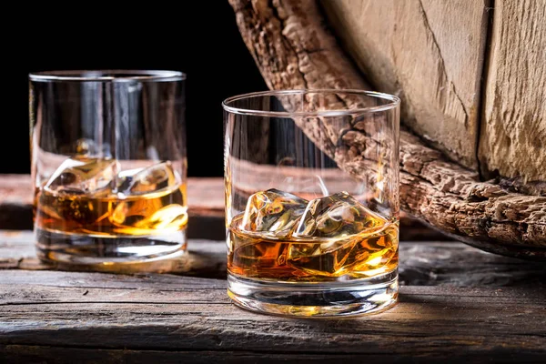 Old and tasty cognac with ice and oak barrel — Stock Photo, Image