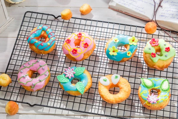 Tasty and various donuts on old wooden table — Stock Photo, Image