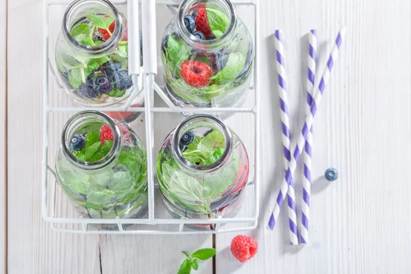 Top view of water in bottle with berries — Stock Photo, Image