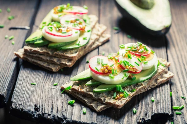 Closeup of tasty sandwich with avocado, eggs and radish — Stock Photo, Image