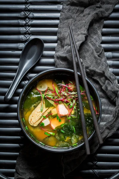 Primo piano della zuppa di miso con salmone su roccia nera — Foto Stock