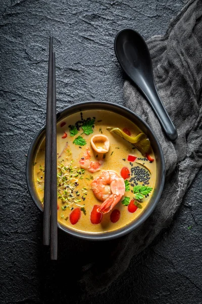 Closeup of Tom Yum soup on black rock — Stok Foto