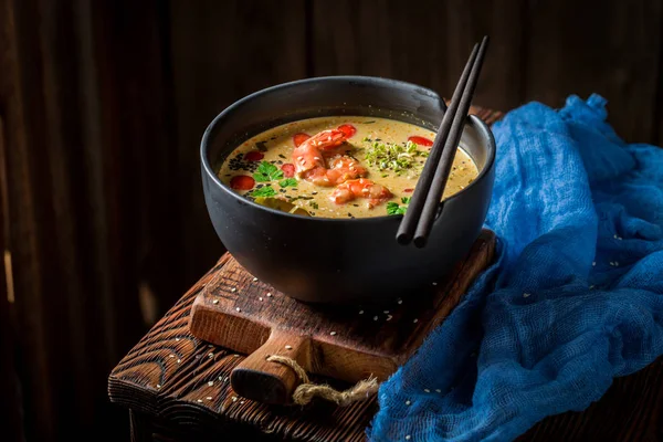 Closeup of hot Tom Yum soup in black bowl — Stock Photo, Image