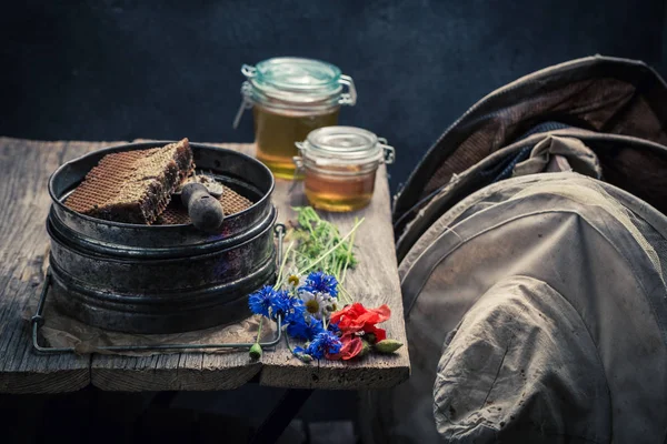 Old beekeeper tools in workshop with honey — Stock Photo, Image