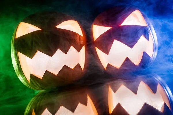 Glowing pumpkins with color smoke for Halloween — Stock Photo, Image