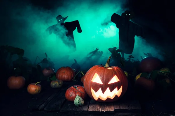 Calabaza aterradora con niebla verde y espantapájaros para Halloween —  Fotos de Stock