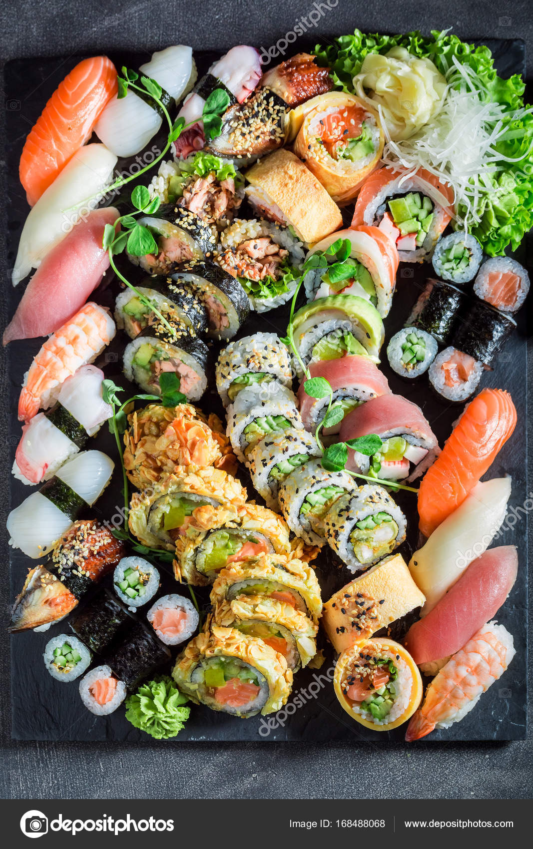 Big sushi set made of fresh vegetables and seafood Stock Photo by