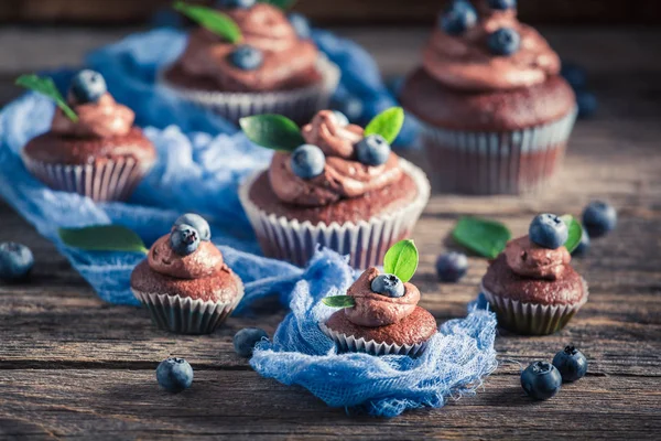 Delicioso muffin de chocolate con arándanos frescos y crema —  Fotos de Stock