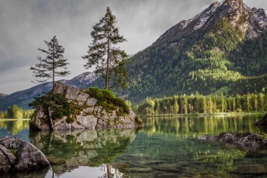 Foggy sunrise at Hintersee lake in Alps in summer clipart