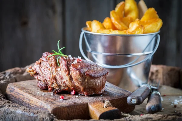 Closeup of steak and chips with rosemary and salt — Stock Photo, Image