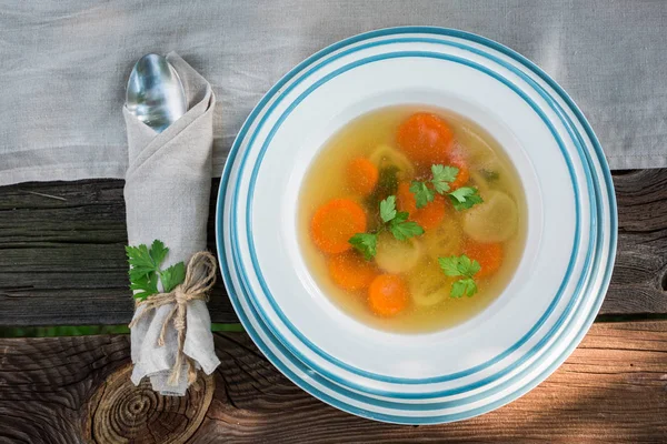 Fresh and tasty chicken soup served in the garden — Stock Photo, Image