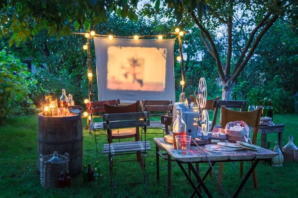 Open-air cinema with drinks and popcorn in the garden