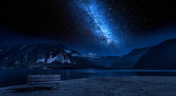 Wooden bench and lake mountain between at night with stars — Stock Photo, Image