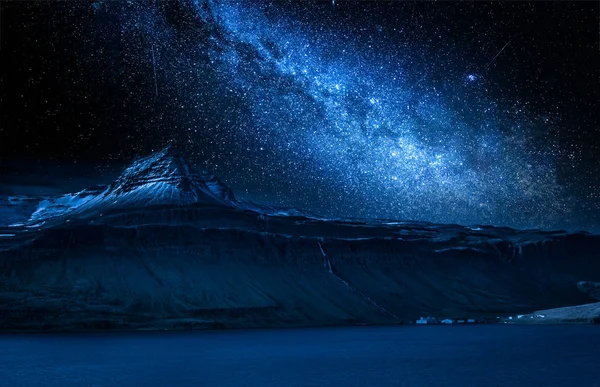 Milky way and volcanic mountain over fjord at night, Iceland — Stock Photo, Image