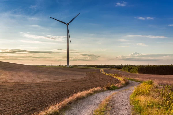 Sunset at countryside with wind turbine in autumn, Poland — Stock Photo, Image