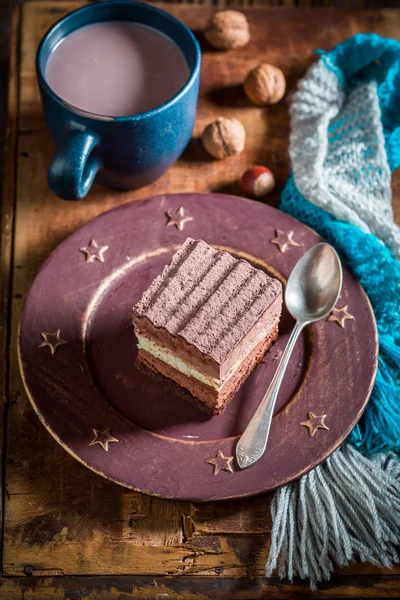 Sweet chocolate cake with hot cocoa in winter — Stock Photo, Image
