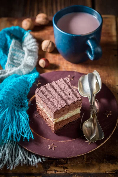 Tasty chocolate cake with hot cocoa in winter — Stock Photo, Image