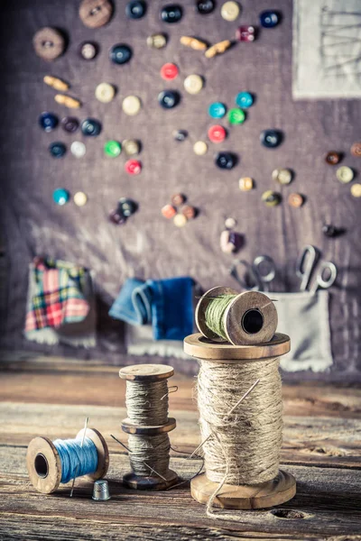 Roscas e agulhas no fundo com esteira de costura — Fotografia de Stock