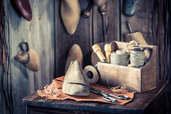 Pequeño lugar de trabajo zapatero con cordones y herramientas —  Fotos de Stock