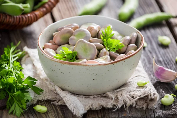 Tasty broad beans boiled with parsley and garlic — Stock Photo, Image