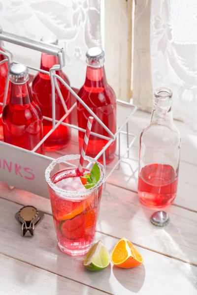 Bebida de verão vermelha em garrafa com folha de hortelã — Fotografia de Stock