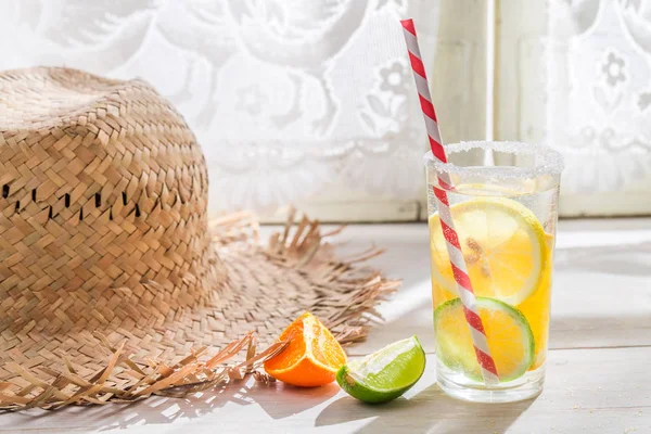 Tasty drink with lemon and orange on white table — Stock Photo, Image