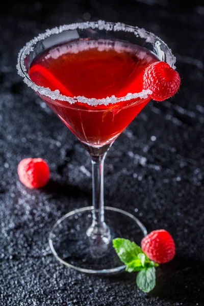 Red Margarita with raspberries and mint on black rock — Stock Photo, Image