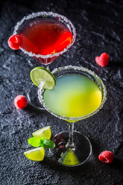 Cold Margarita with fresh fruits on black rock — Stock Photo, Image