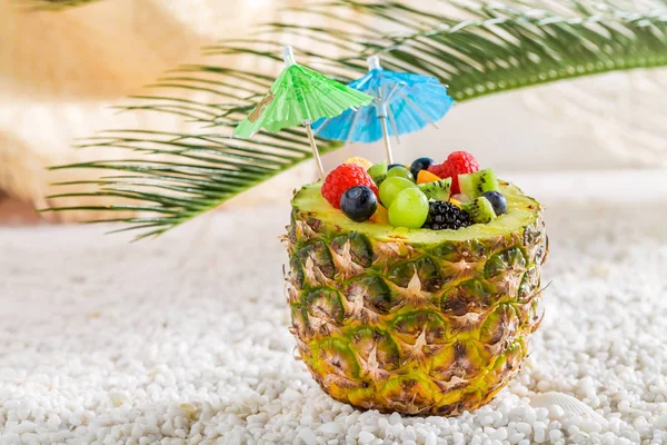 Tropisk fruktsallad i ananas på vita stenar — Stockfoto