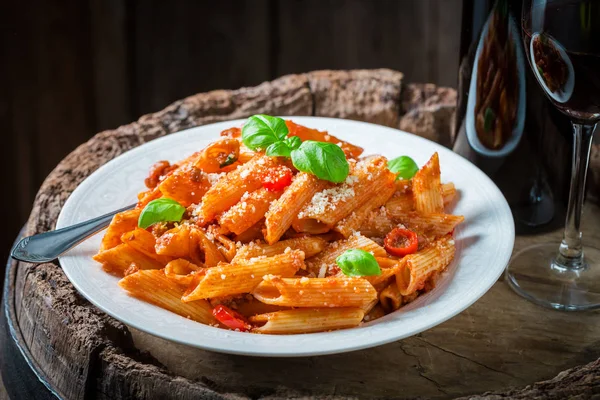 Tasty penne bolognese with parmesan and red wine — Stock Photo, Image