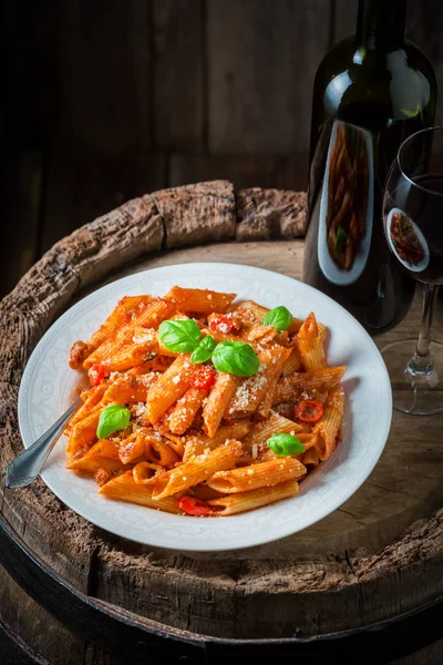 Enjoy your penne bolognese with parmesan and red wine — Stock Photo, Image