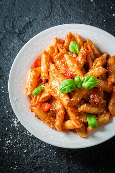 Closeup of penne bolognese with parmesan and basil — Stock Photo, Image