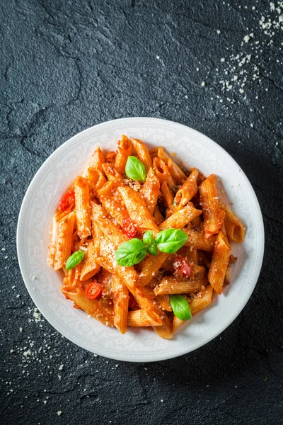 Delicious penne bolognese with parmesan and basil — Stock Photo, Image