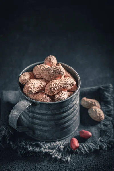 Fresh peanuts with in old rustic metal mug — Stock Photo, Image