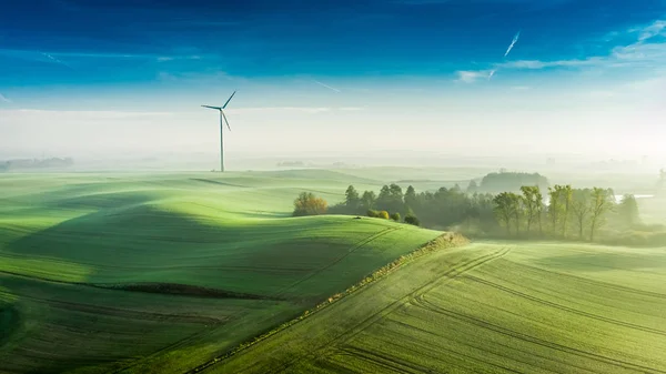 Foggy wind turbine at sunrise, view from above — Stock Photo, Image