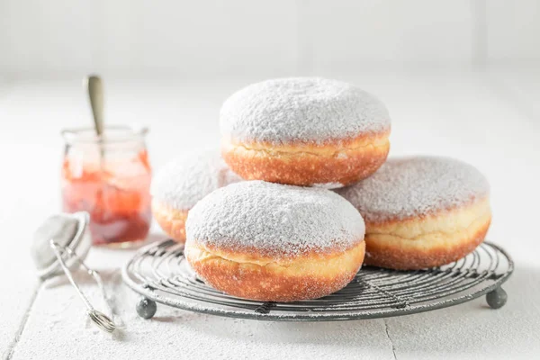 Closeup of tasty donuts with powdered sugar on white table — Stock Photo, Image